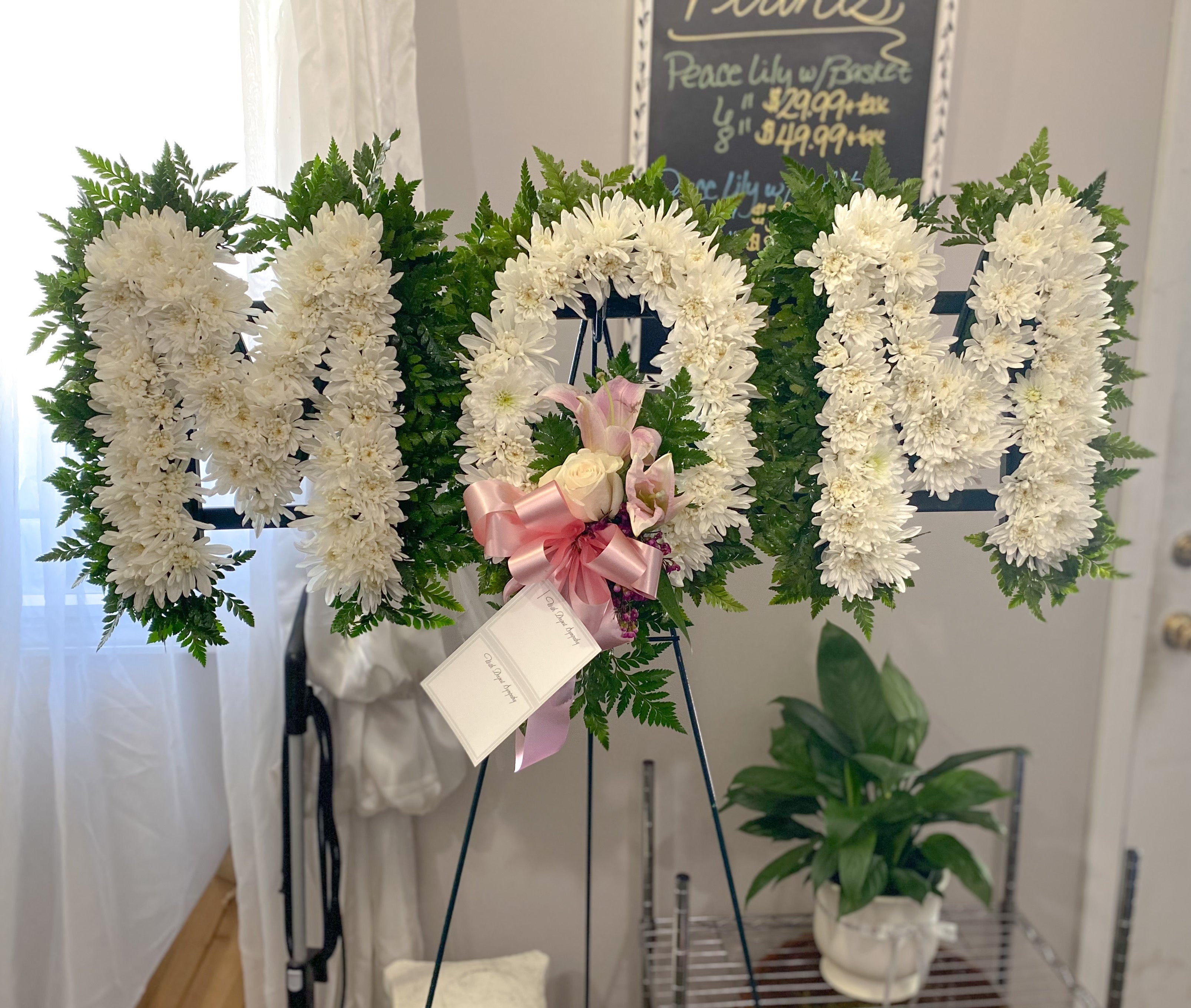 A floral memorial sign spelling &
