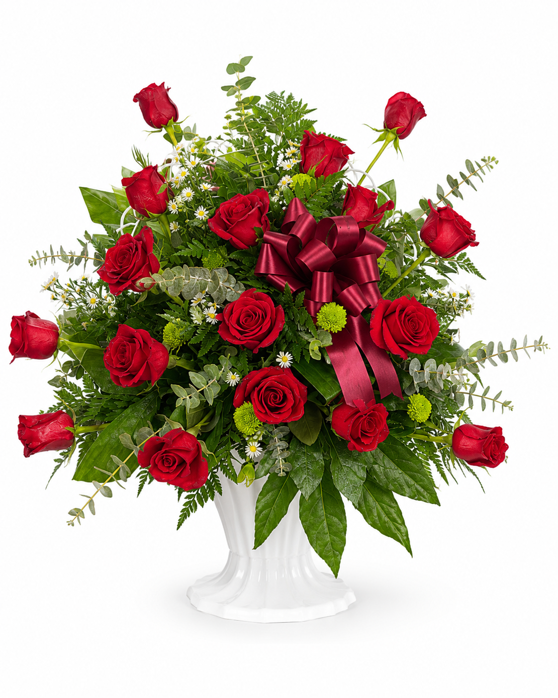 Red rose sympathy flower arrangement with fillers and greenery in a white pedestal urn. White background