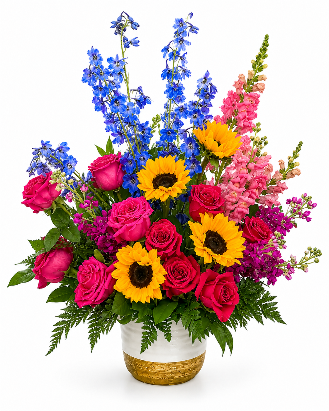 A colorful pedestal sympathy arrangement featuring bright yellow sunflowers, hot pink roses, blue delphinium, pink snapdragons, purple stock, lush greenery, and seasonal accent flowers arranged in an elegant white ceramic pedestal container with a gold base. The vibrant garden-style design symbolizes hope, joy, and a life beautifully remembered, making it suitable for funeral services, memorials, and celebrations of life.