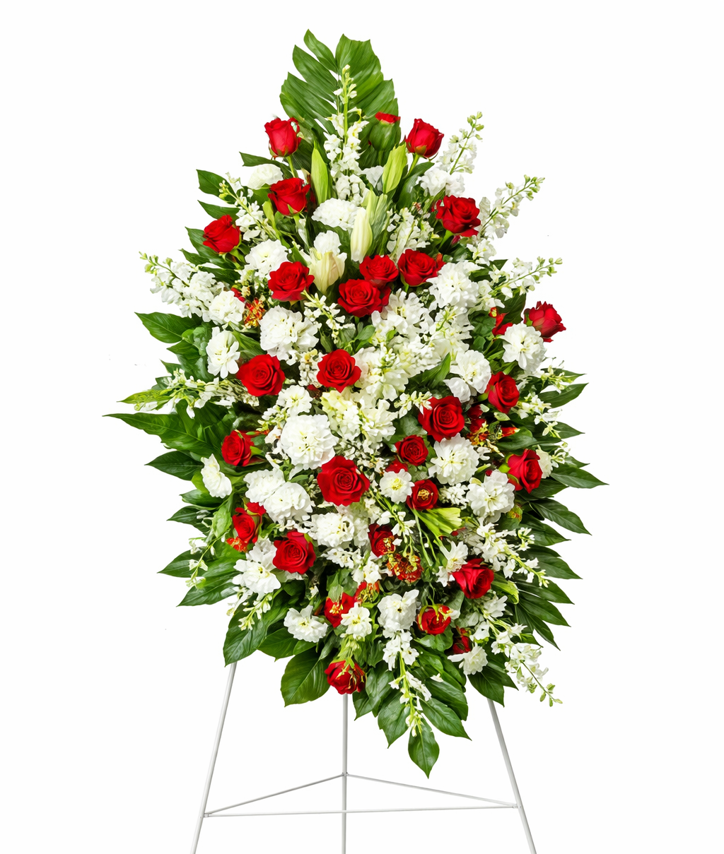 A standing funeral spray featuring red roses and white flowers arranged with lush greenery on a metal easel, displayed against a clean white background.