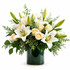 Elegant white floral arrangement featuring white lilies and ivory roses accented with soft greenery and delicate filler flowers, designed in a lush, rounded style and displayed in glass vase with green ribbon, against a clean white background.