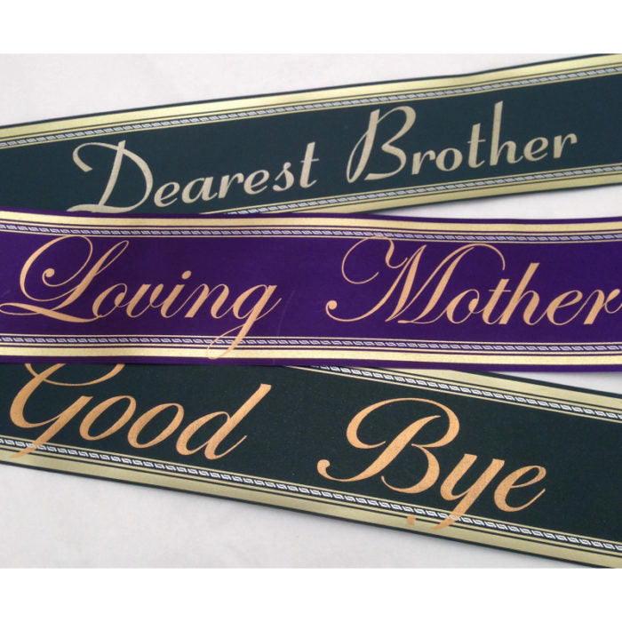 Funeral tribute ribbons featuring scripted messages reading “Dearest Brother,” “Loving Mother,” and “Good Bye,” displayed in elegant gold lettering on black and purple satin ribbons against a light background.
