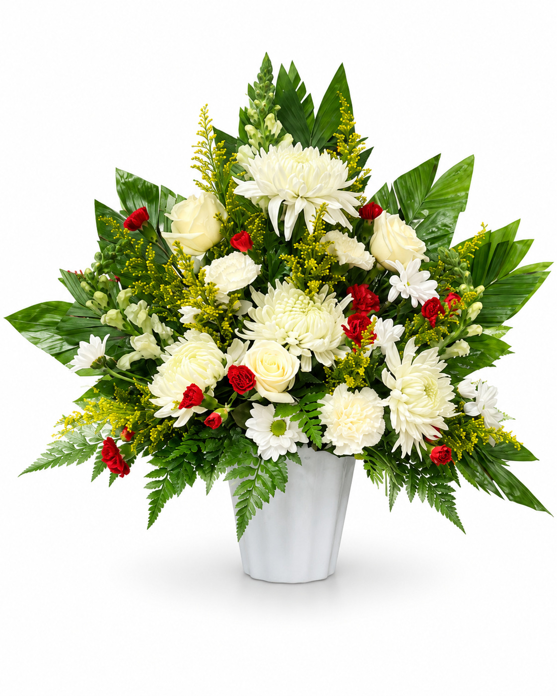 Elegant sympathy flower arrangement featuring white chrysanthemums, roses, yellow solidago, red mini carnations and greenery in a white plastic container. All white background.